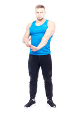 Portrait of well-muscled male athlete stretching his arms isolated on white