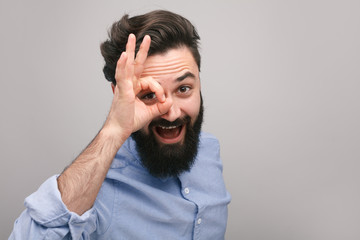 Smiling guy showing OK gesture at camera