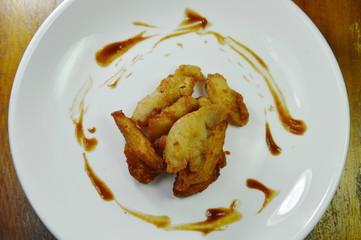 deep fried chicken dressing tomato sauce on white plate