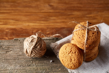 Homemade cookies on homespun napkin over wooden table, close-up, selective focus
