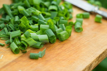 Sliced green onion on a kitchen board