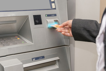 Woman hand used ATM card or credit card for withdraw money from ATM machine.