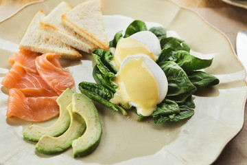 Healthy breakfast with poached eggs and smoked salm