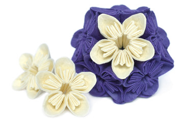 Purple and white origami kusudama flower on white background