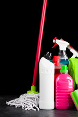 Cleaning supplies on black background