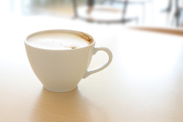 Coffee cup of latte on table in shop.