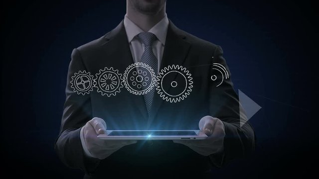Businessman lifting smart pad, tablet, Drawing business concept with gear wheel, goal, vision, idea, team work, success. 4k Animation.