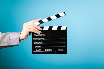 Female hands holding a clapperboard
