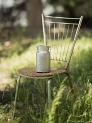 Retro little barrel for milk stands on a chair against