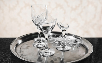 Tray with a broken wine glass on top of a balcony.