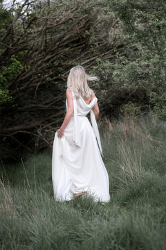 Beautiful woman - the bride. Boho style woman. Barefoot beautiful woman on the clearing. Natural, Nymph.