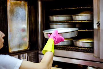 Woman baker working in bakery shop