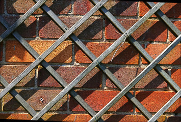 Wooden trellis on brick wall closeup