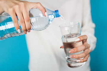 Woman filling a glass of water