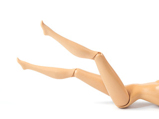 The beautiful slender legs of pretty figure girl doll doing gestures sexy isolated on white background