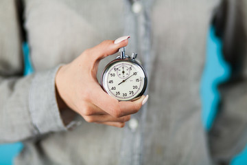 Female hand holding a stopwatch - Powered by Adobe