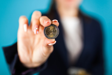 Woman holding a 2 Euro coin