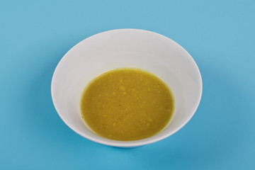 Creamy broccoli soup on a blue