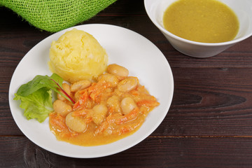 Beans with carrots and potatoes on a table