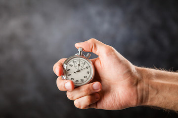 Analog stopwatch on black background