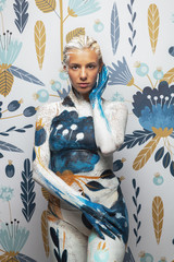 Woman in paint. Attractive sexy girl flowers plants body art merge with the environment like...