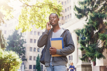 Young student talking on smartphone in the park