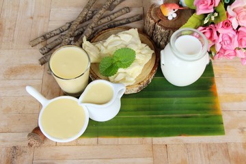 Dip cheese with milk on wood background