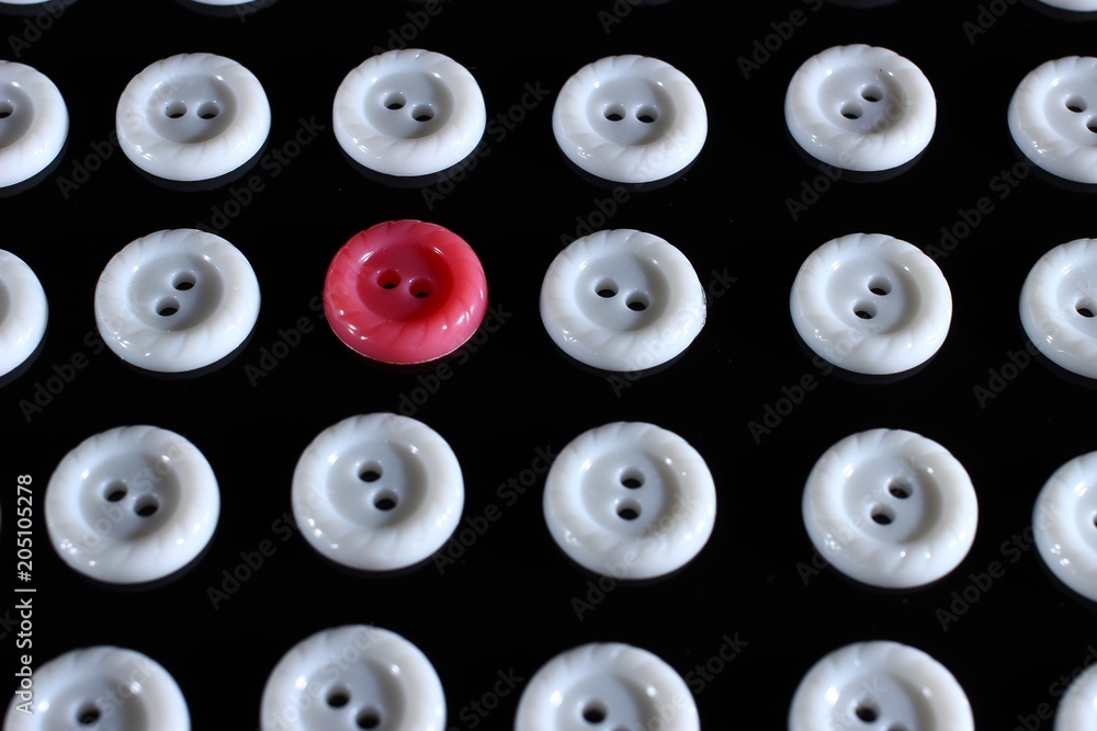 Poster white buttons on a dark background and someone else's button of another color