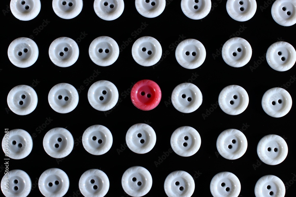 Poster white buttons on a dark background and someone else's button of another color