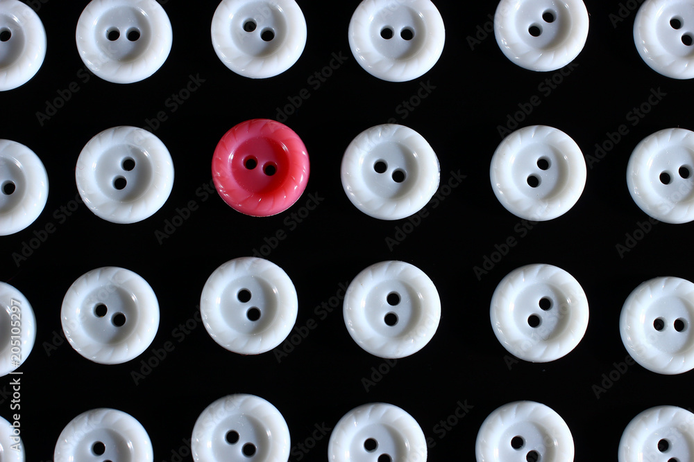 Poster white buttons on a dark background and someone else's button of another color