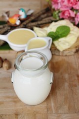 Dip cheese with milk on wood background