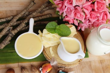 Dip cheese with milk on wood background