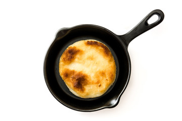 Arepas in frying pan isolated on white background. Venezuelan typical food. Top view