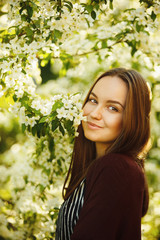 lovely woman with a blooming tree street.