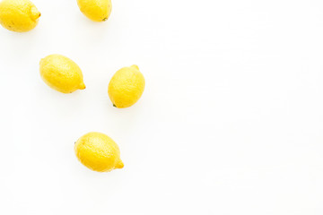 Bright lemons on white background. Flat lay, top view.