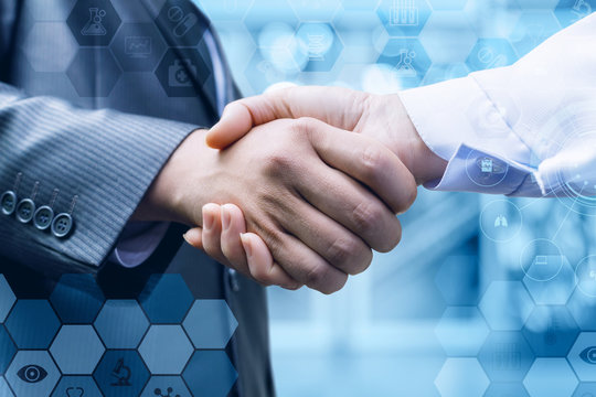 Handshake of a businessman and a doctor .
