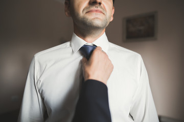 Young handsome man relaxing at his apartment in a hotel after business meeting
