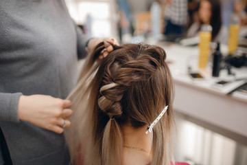 Fototapeta premium Woman teacher helping students girl training to hairdressers