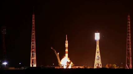 Tilt up, rocket launches at night