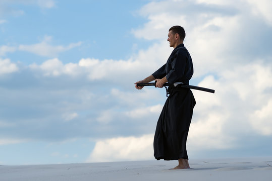 Man practicing Japanese martial art in desret