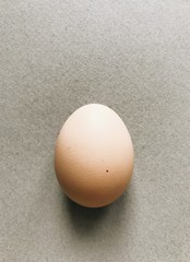 Chicken homemade egg on a gray background. 