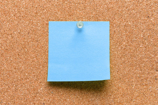 empty square blue pinned sheet on a brown cork reminder