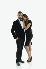 portrait of an elegant woman in a black dress hugging her lover