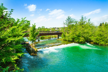 Fototapeta premium Panoramic view on waterfall and wooden bridge on Mreznica river in Belavici, Croatia 