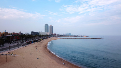 Fototapeta premium Aerial view of Barcelona and the Mediterranean in the evening
