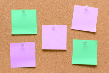 empty square green and purple pinned sheet on a brown cork reminder