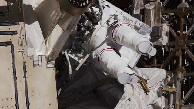 Astronaut works on International Space Station exterior