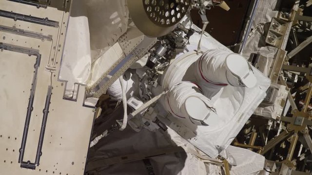 Astronaut works on outside of International Space Station