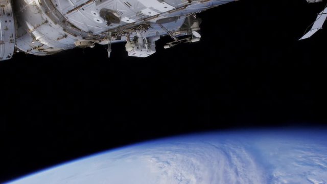 Tilt down, astronaut works on outside of International Space Station