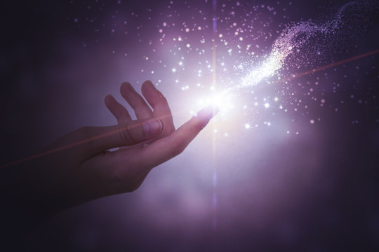 A Hand Giving The Flow Of Energy. Magic, Fantasy. Glowing Particles